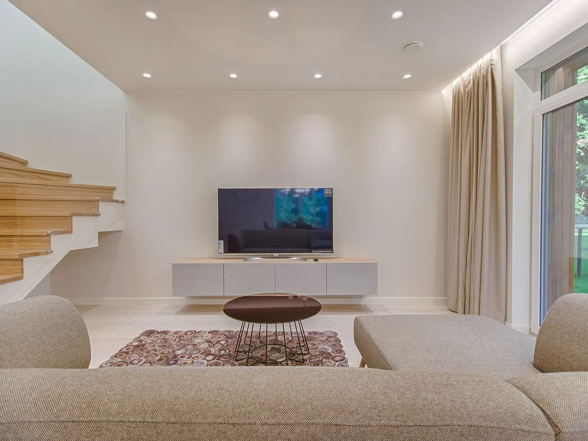 TCL 65 Inch 4K Google TV in a living room setting